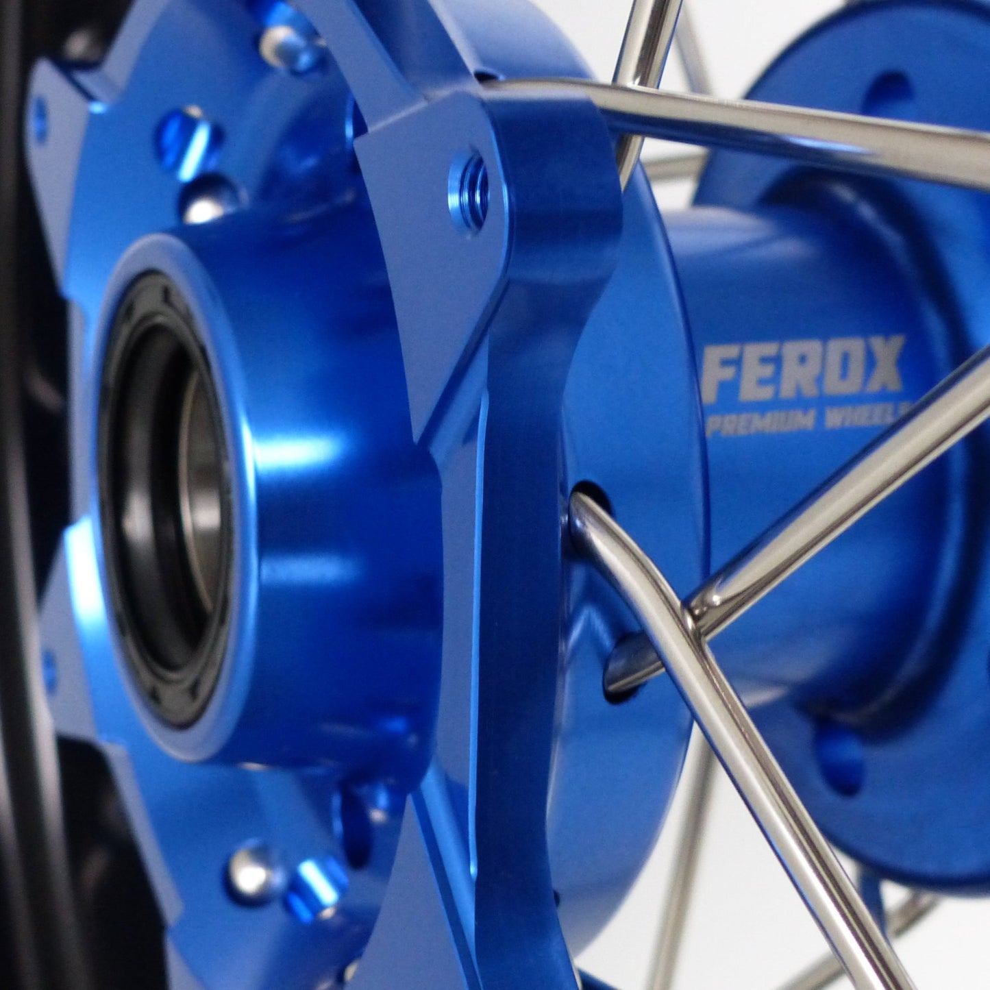 Supermoto wheels, blue hubs, silver spokes, blue nipples, black rim