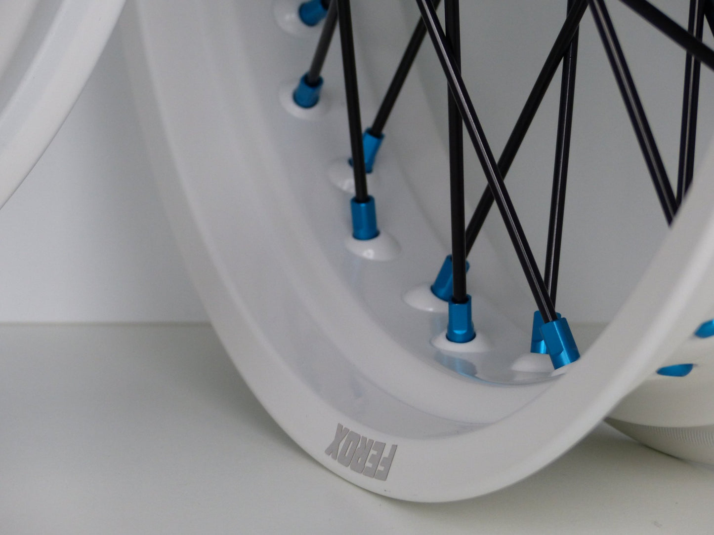 White rim, Black spokes, Light Blue nipples, Light Blue hub